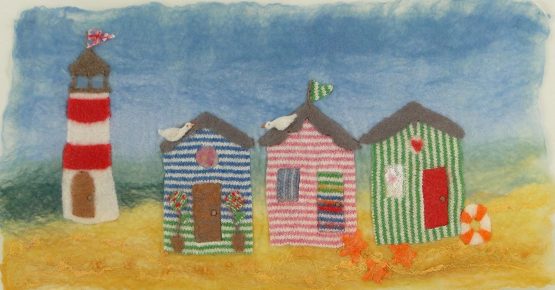 Artfelt beach hut picture felt kit- a carefully designed felting kit to make a colourful seaside scene with beach huts and a lighthouse.